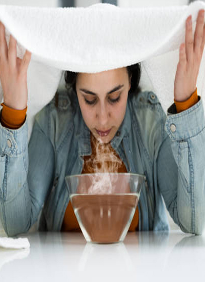 Image of girl having Steam from big Glass bowl and white towel represent Steam Therapy